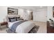Modern bedroom with soft carpet, bedside tables with lamps and large closets at 5467 W Hinsdale Pl, Littleton, CO 80128