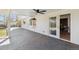 Spacious covered deck area perfect for outdoor entertaining and relaxation with modern ceiling fan at 5467 W Hinsdale Pl, Littleton, CO 80128