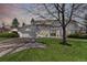 Charming two-story home featuring a well-manicured lawn, mature landscaping, and an attached garage at 5467 W Hinsdale Pl, Littleton, CO 80128