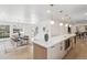 Open concept kitchen with modern island and adjacent dining area creates an inviting space at 5467 W Hinsdale Pl, Littleton, CO 80128