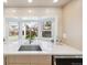 A modern kitchen sink is under a bay window providing natural light and a view of the backyard at 5467 W Hinsdale Pl, Littleton, CO 80128