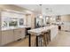 Bright and modern kitchen with an island, stainless steel appliances, and elegant pendant lighting at 5467 W Hinsdale Pl, Littleton, CO 80128