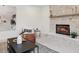 Cozy living room with a stone fireplace, comfortable seating, and modern decor at 5467 W Hinsdale Pl, Littleton, CO 80128