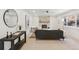 Bright living room features a stone fireplace, large windows, modern decor, and a comfortable seating area at 5467 W Hinsdale Pl, Littleton, CO 80128