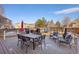 Backyard deck with dining and seating areas, grill, and play set, perfect for entertaining at 5232 Creek Way, Parker, CO 80134