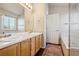 Bright bathroom with double vanity, large mirror, and separate tub and shower at 5232 Creek Way, Parker, CO 80134