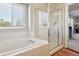 Bathroom showcasing a separate soaking tub and glass-enclosed shower with natural light at 5232 Creek Way, Parker, CO 80134