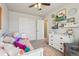 Bright bedroom with fun decor, closet, dresser and colorful pillows and pink rug at 5232 Creek Way, Parker, CO 80134