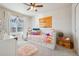 Brightly decorated bedroom with daybed, fun decorations, and natural light streaming through the window at 5232 Creek Way, Parker, CO 80134