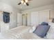 Well-lit bedroom with sliding closet doors and modern decor, including a macrame wall hanging at 5232 Creek Way, Parker, CO 80134