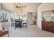 Bright dining area with high ceilings, large windows, and a decorative gallery wall featuring unique and charming artwork at 5232 Creek Way, Parker, CO 80134