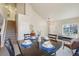 Open floor plan reveals a dining space with a view of the staircase and an abundance of natural light streaming through the windows at 5232 Creek Way, Parker, CO 80134