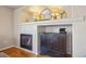 Close-up of the modern fireplace with unique tile surround and decorative mantle display at 5232 Creek Way, Parker, CO 80134