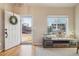 Bright foyer with hardwood floors, a large window, and charming decor for an inviting entrance at 5232 Creek Way, Parker, CO 80134