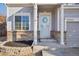 Inviting front porch with decorative wreath and classic brick accents, number 5232 is visible at 5232 Creek Way, Parker, CO 80134