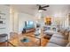 Open-concept living room seamlessly connects to the kitchen, featuring hardwood floors and comfortable seating at 5232 Creek Way, Parker, CO 80134