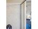 Close-up of a shower with tiled walls and a glimpse into the main bedroom at 5232 Creek Way, Parker, CO 80134