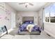 Charming bedroom with floral accents, comfortable bed, ceiling fan, and natural light from the window at 8035 S Kewaunee St, Aurora, CO 80016