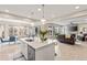 Bright, open kitchen featuring a large island with modern pendant lighting and an eat-in dining area at 8035 S Kewaunee St, Aurora, CO 80016