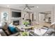 Open living room featuring a fireplace, ceiling fan, and seamless transition to the dining area at 8035 S Kewaunee St, Aurora, CO 80016