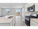 Modern kitchen with island, stainless steel appliances and white cabinets at 5710 Ranch St, Mead, CO 80504