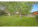Large backyard with well-maintained lawn, mature tree, and partial fencing at 8269 Zephyr St, Arvada, CO 80005