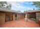 Backyard featuring a brick home with a wooden deck and pergola at 8269 Zephyr St, Arvada, CO 80005