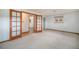 Spacious bedroom with neutral carpet, double doors, and a view of the exterior at 8269 Zephyr St, Arvada, CO 80005
