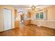 Dining room featuring hardwood floors, bright walls and window with an adjoining kitchen at 8269 Zephyr St, Arvada, CO 80005