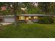 Charming single Gathering home featuring a brick exterior, attached garage and landscaped yard at dusk at 8269 Zephyr St, Arvada, CO 80005