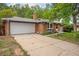 Charming single Gathering home featuring a brick exterior, attached garage and driveway with landscaped yard at 8269 Zephyr St, Arvada, CO 80005