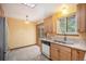 Bright kitchen with wood cabinets, stainless refrigerator, granite countertops and a tile floor at 8269 Zephyr St, Arvada, CO 80005