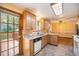 Bright kitchen with wood cabinets, stone countertops, and access to the backyard deck at 8269 Zephyr St, Arvada, CO 80005