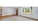 Bright living room features a large bay window for natural light, carpet and wood flooring, and a wooden door at 8269 Zephyr St, Arvada, CO 80005