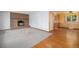 Living room featuring a brick fireplace, new carpet and hardwood floors and lots of space at 8269 Zephyr St, Arvada, CO 80005