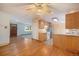 Open-concept living space with hardwood floors, and kitchen that features bright cabinets and stainless appliances at 8269 Zephyr St, Arvada, CO 80005