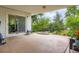 Covered back patio with seating and sliding door leading to a green backyard at 6748 S Gallup St, Littleton, CO 80120