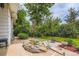 Spacious backyard with pond, landscaping, patio, fire pit, and lush greenery at 6748 S Gallup St, Littleton, CO 80120