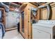 Basement space with wood sauna, concrete floor, exposed ceiling, and laundry area at 6748 S Gallup St, Littleton, CO 80120