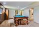 Basement with a pool table, and doorway to an additional room for flexible use at 6748 S Gallup St, Littleton, CO 80120