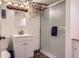 Cozy bathroom with a single vanity, frosted glass shower, and unique fish-themed decor at 6748 S Gallup St, Littleton, CO 80120