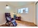 Well-lit room with hardwood floors, large window, and a comfortable looking recliner at 6748 S Gallup St, Littleton, CO 80120