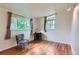 Bright, airy bedroom with hardwood floors and natural light coming through the two large windows at 6748 S Gallup St, Littleton, CO 80120