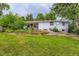 Home exterior with large yard, established landscaping, and back patio at 6748 S Gallup St, Littleton, CO 80120