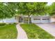 Charming ranch-style home featuring a well-manicured lawn and a two-car garage, ideal for suburban living at 6748 S Gallup St, Littleton, CO 80120