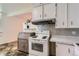 Efficient kitchen layout featuring a stove and ample counter space, perfect for culinary enthusiasts at 6748 S Gallup St, Littleton, CO 80120