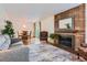 Inviting living room featuring a classic brick fireplace and ample seating, great for Gathering gatherings at 6748 S Gallup St, Littleton, CO 80120