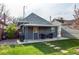 Back exterior showing outdoor entertaining space and backyard at 3052 S Cherokee St, Englewood, CO 80110
