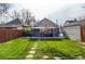 Landscaped backyard featuring a lush lawn and charming stone pathway at 3052 S Cherokee St, Englewood, CO 80110
