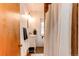 Bathroom featuring a white vanity, tiled shower with curtain, and neutral paint at 3052 S Cherokee St, Englewood, CO 80110